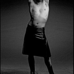 portrait of actor Alan Cumming in skirt and shirtless black and white fine art photography by photographer Clive Arrowsmith